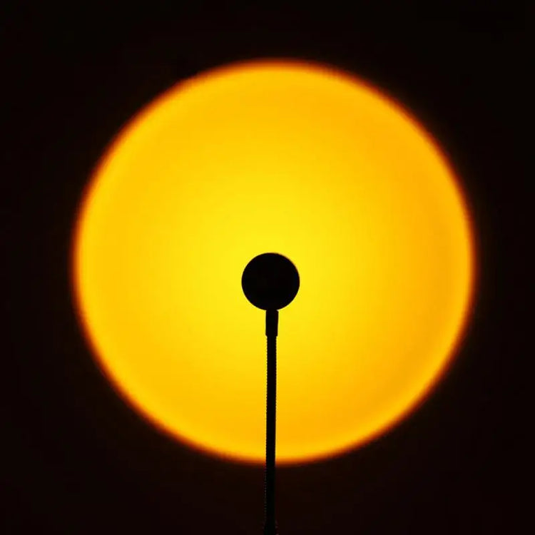 Sunset projection lamp illuminating room with colorful light