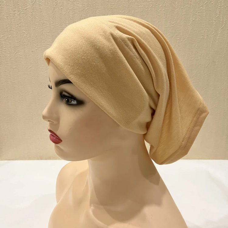 Lightweight spandex turban bonnet in beige, styled under a chiffon hijab