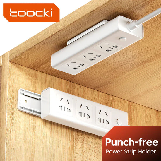 Toocki socket strip fixator holding a power strip in place on a tiled kitchen wall