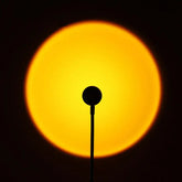 Sunset projection lamp illuminating room with colorful light