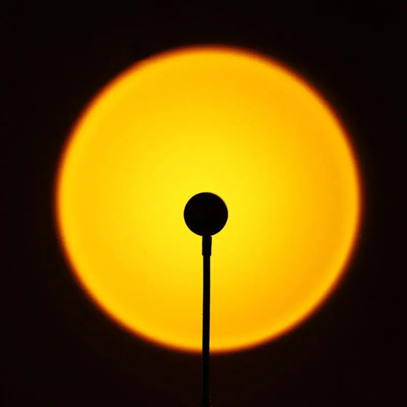 Sunset projection lamp illuminating room with colorful light