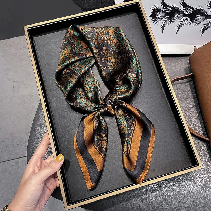 Elegant silk-feel scarf featuring intricate patterns, used as a headband or hair accessory