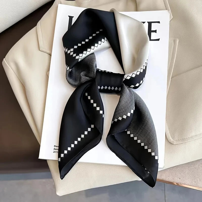 Elegant silk-feel scarf featuring intricate patterns, used as a headband or hair accessory