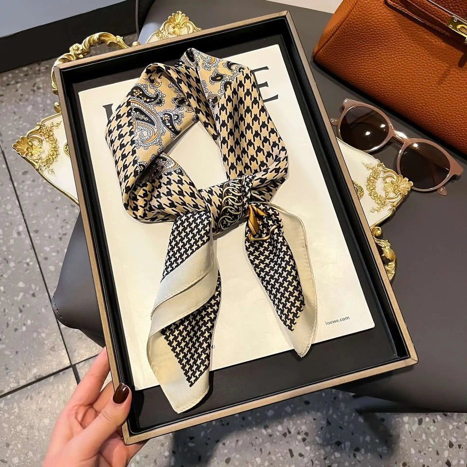 Elegant silk-feel scarf featuring intricate patterns, used as a headband or hair accessory