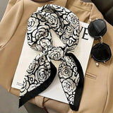 Elegant silk-feel scarf featuring intricate patterns, used as a headband or hair accessory