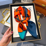 Elegant silk-feel scarf featuring intricate patterns, used as a headband or hair accessory