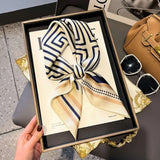 Elegant silk-feel scarf featuring intricate patterns, used as a headband or hair accessory
