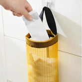 Hanging grey nylon bag holder for organizing plastic bags under cabinets or on walls