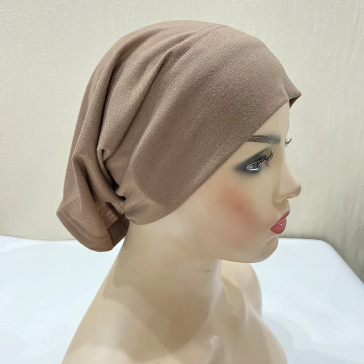 Lightweight spandex turban bonnet in beige, styled under a chiffon hijab