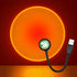Sunset projection lamp illuminating room with colorful light