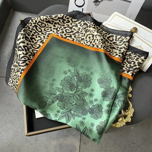 Elegant silk-feel scarf featuring intricate patterns, used as a headband or hair accessory