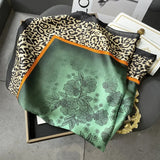 Elegant silk-feel scarf featuring intricate patterns, used as a headband or hair accessory