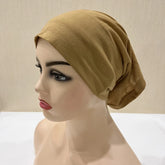 Lightweight spandex turban bonnet in beige, styled under a chiffon hijab