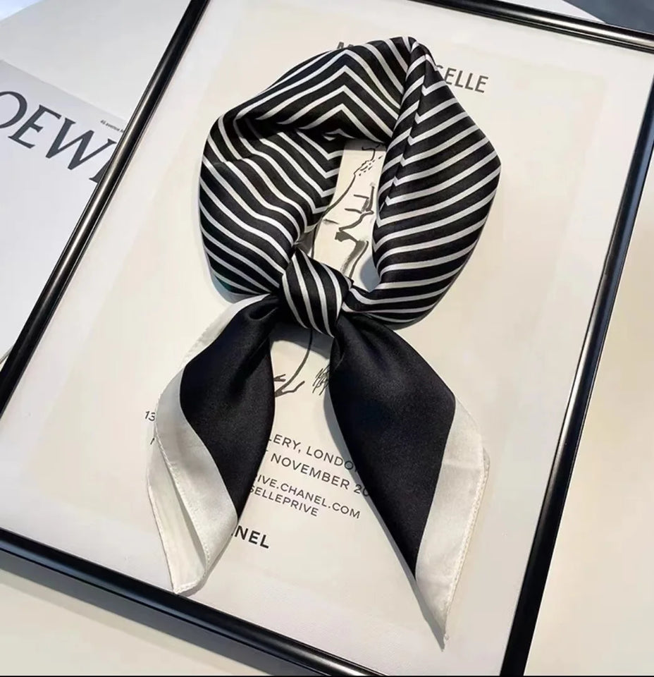 Elegant silk-feel scarf featuring intricate patterns, used as a headband or hair accessory