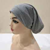 Lightweight spandex turban bonnet in beige, styled under a chiffon hijab